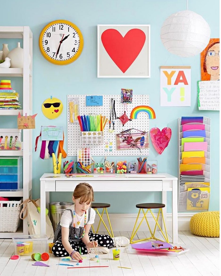 Colorful kids room with pegboard on the wall.