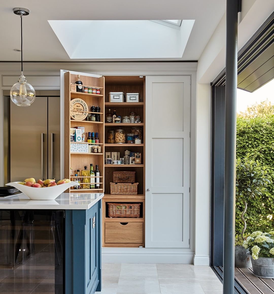 Built-in hidden pantry in kitchen. Photo by Instagram user @tomhowleykitchens