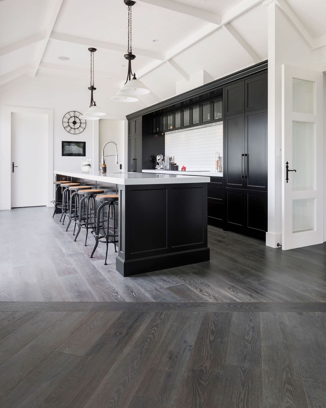 gray flooring in a basement with a full counter and bar photo by Instagram user @forteflooring