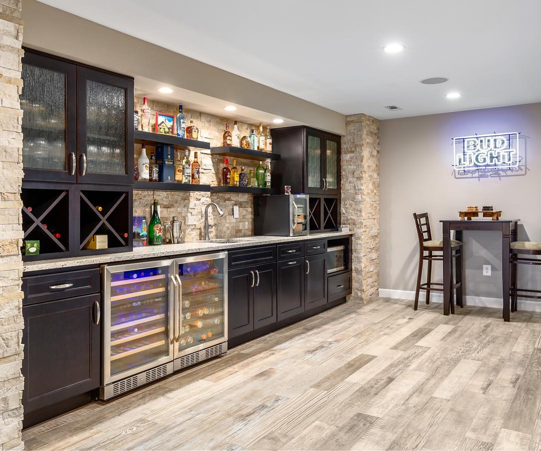 basement with full wet bar with cabinets and fridges photo by Instagram user @kbfbyaudicontractors