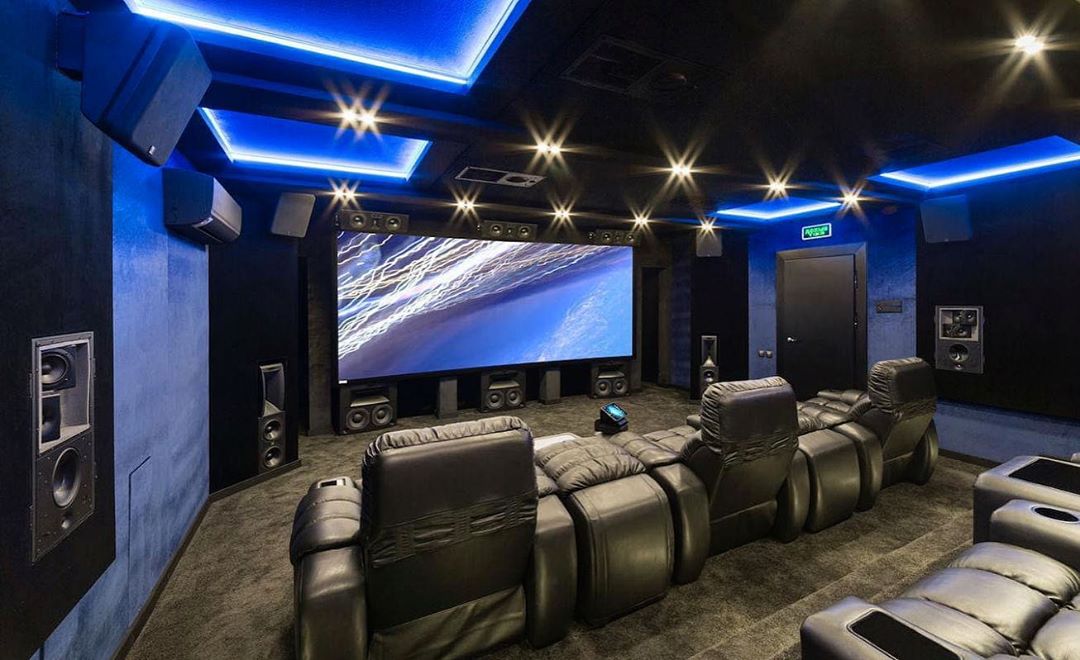 home theater space with nice reclining chairs and projector screen photo by Instagram user @woodys_soundup
