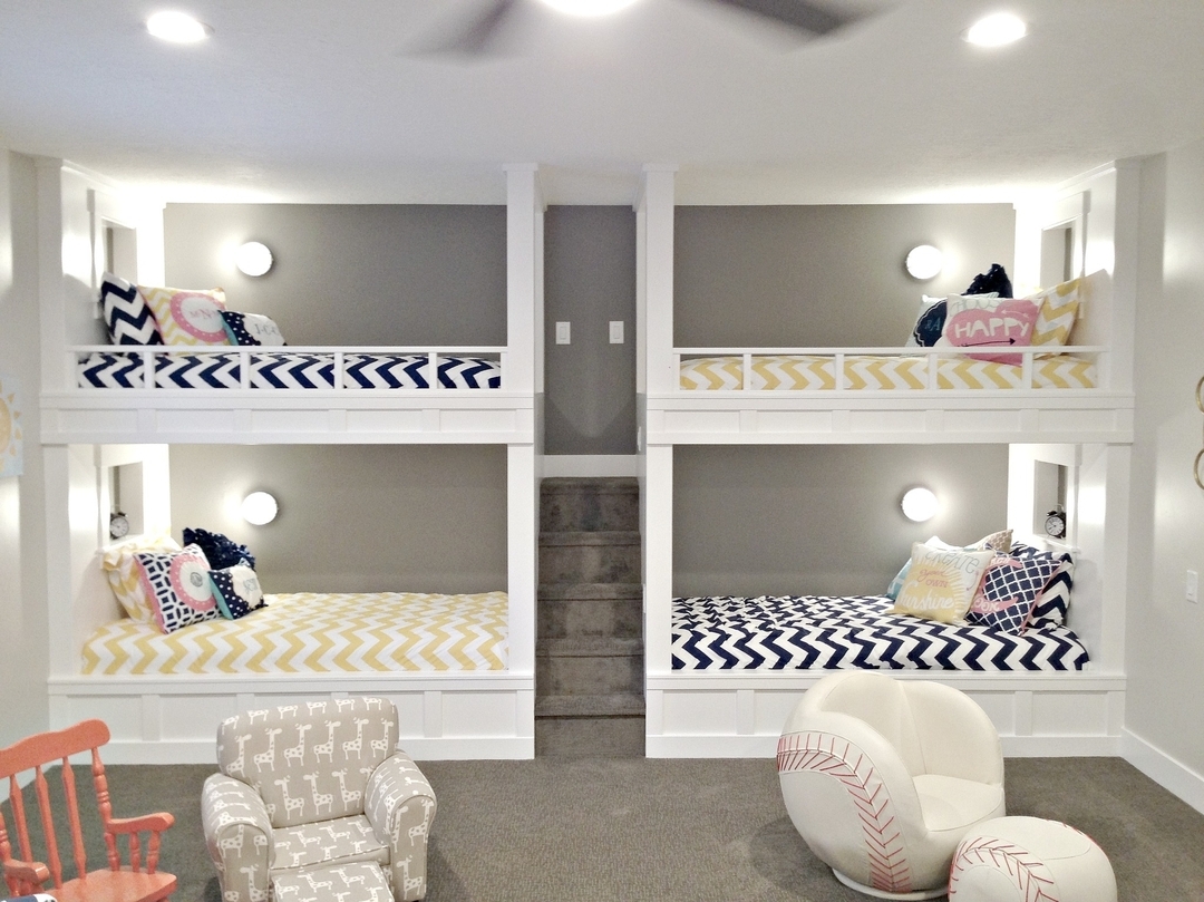basement bedroom with four bunk beds and small childrens chairs nearby photo by Instagram user @remodelaholic