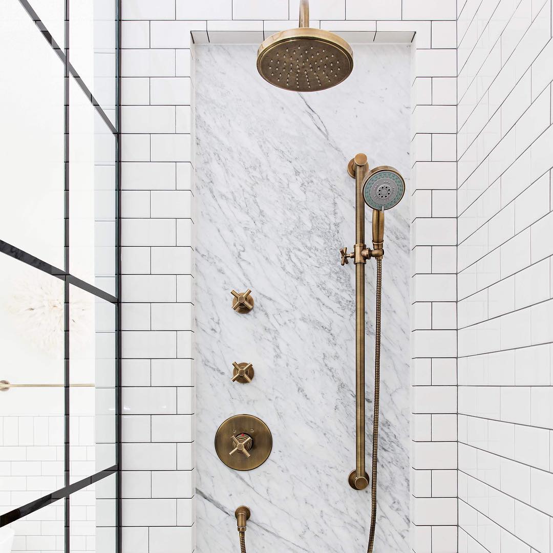 Shower with brass fixtures. Photo by Instagram user @in.house.design