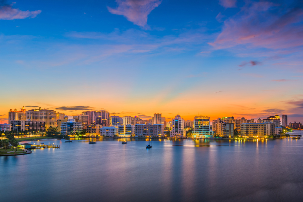 aerial view of sarasota coastal line and skyline of downtown at dusk
