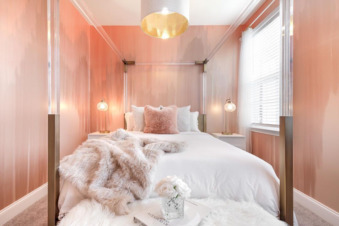 Bedroom with decorative lighting on the wall.