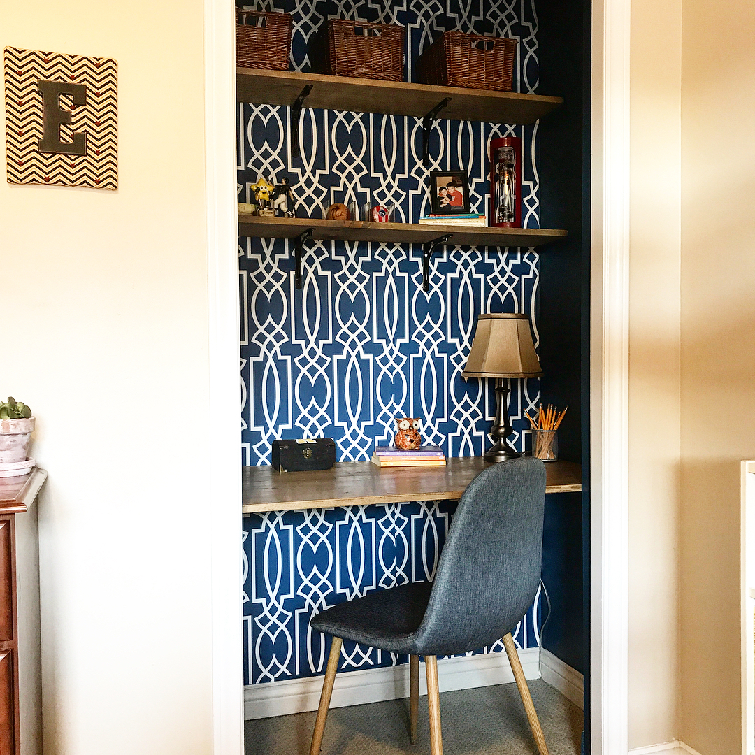 Open bedroom closet with desk and chair for studying.