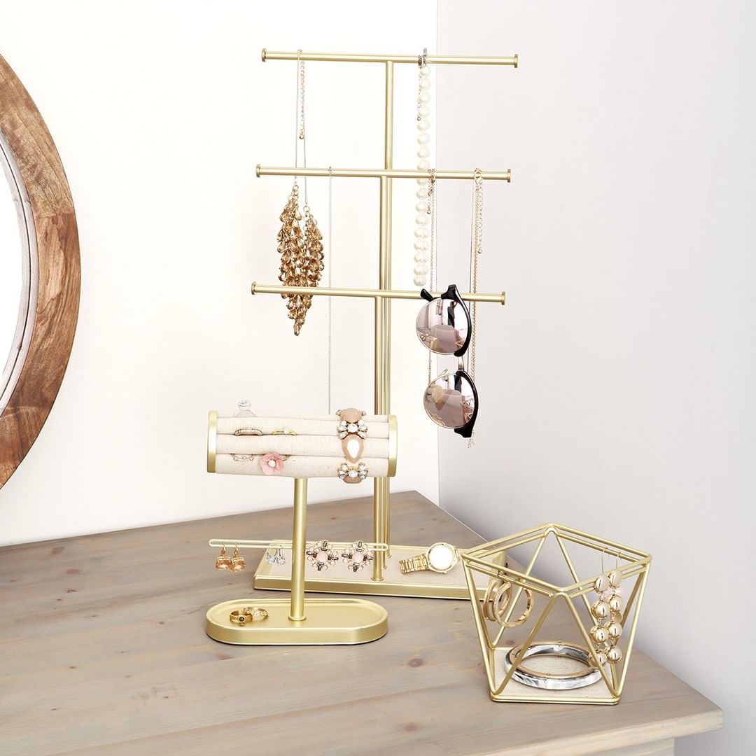 Jewelry storage display with necklaces and sunglasses.