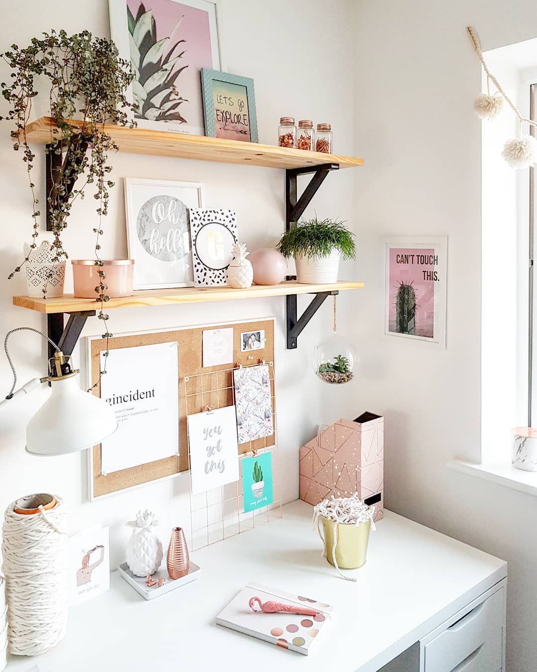 Study nook with desk and books in corner of bedroom.