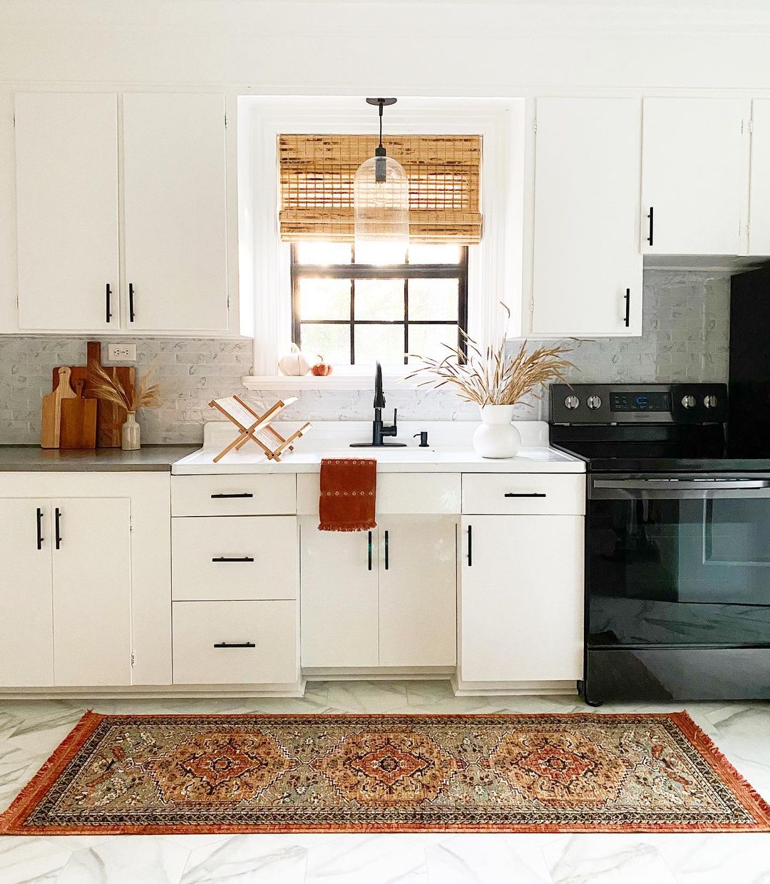 Minimalist Style Kitchen with White Cabinents and Area Rug. Photo by Instagram user @modernly_you