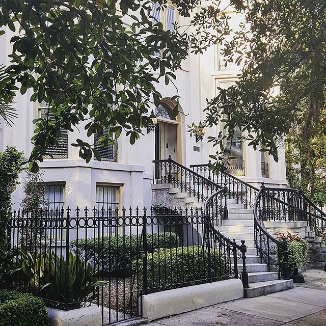 An elegant Victorian home with iron railings and granite steps. Photo by Instagram user @luckysavannah.