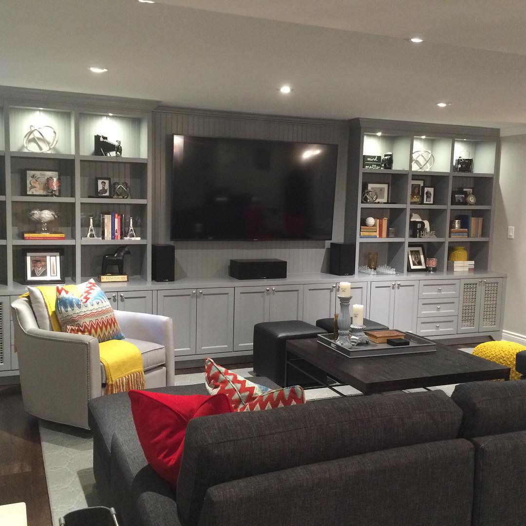 Basement Family Room with TV and Built In Shelves on the Wall. Photo by Instagram user @janelockhartdesign