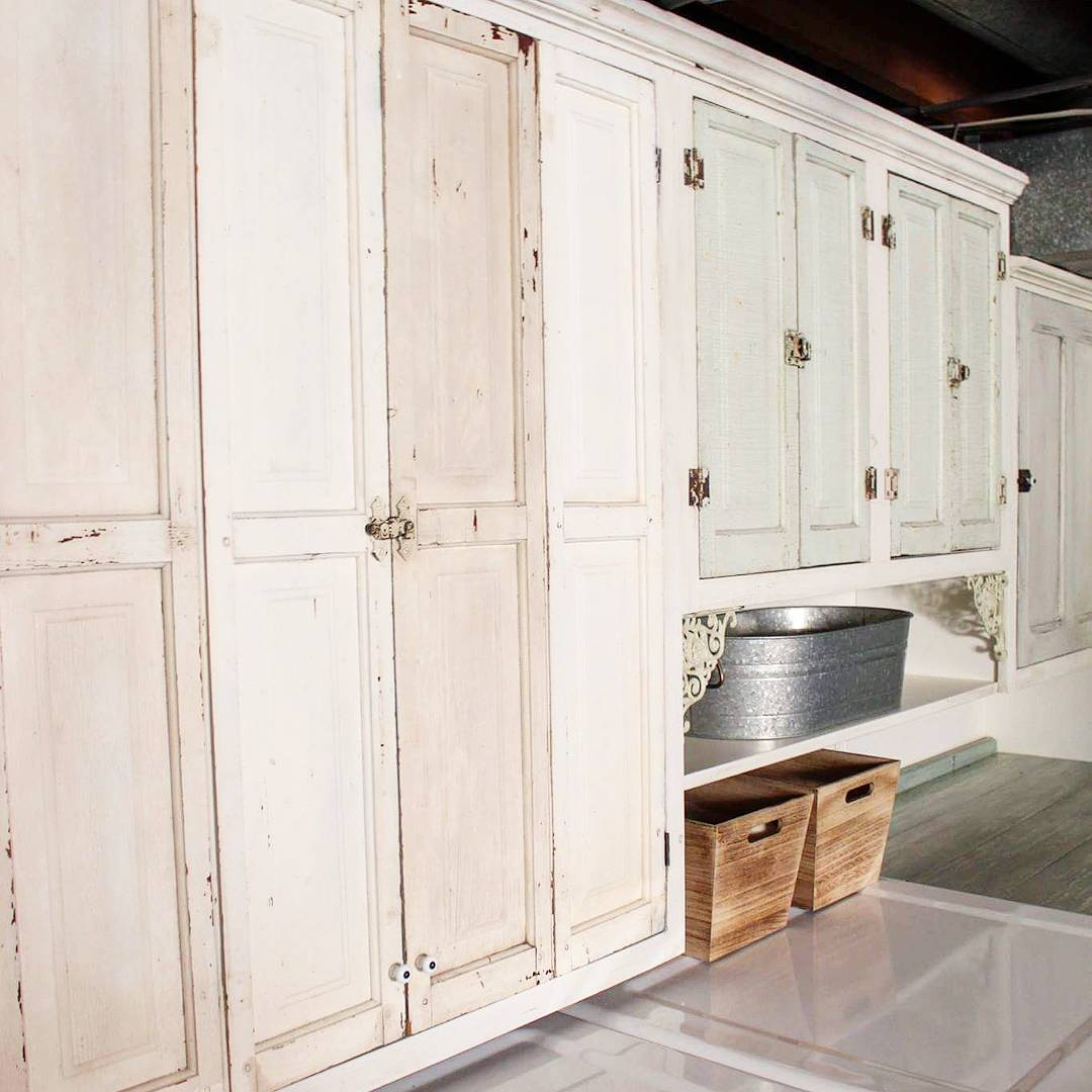 Old Kitchen Cabinets Reinstalled in Basement for Storage. Photo by Instagram user @cjperiwinkle