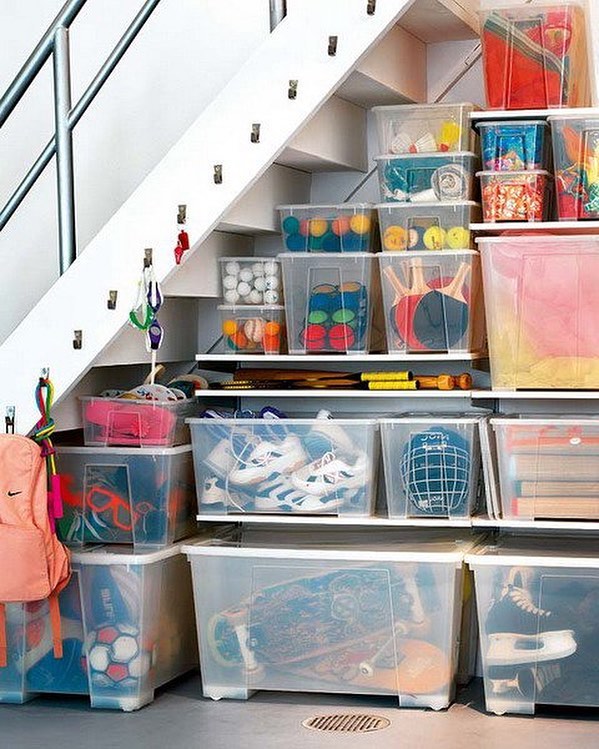 Clear Totes Stored Underneath the Basement Stairs. Photo by Instagram user @organizerjanet