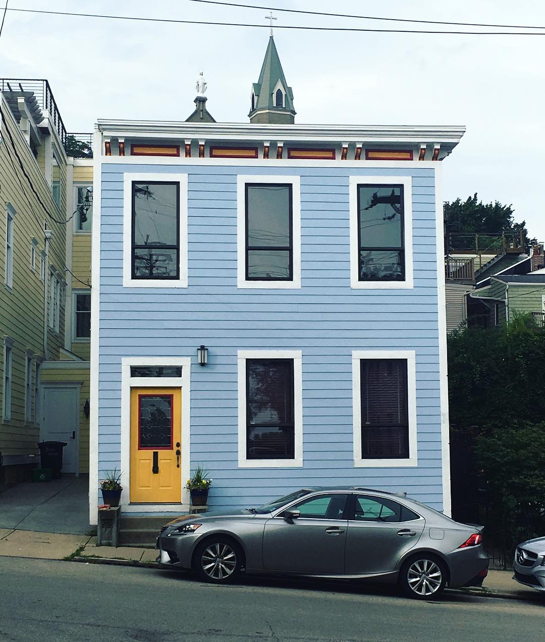 Two story blue home with yellow story in Cincinnati. Photo by Instagram user @takeintheview_