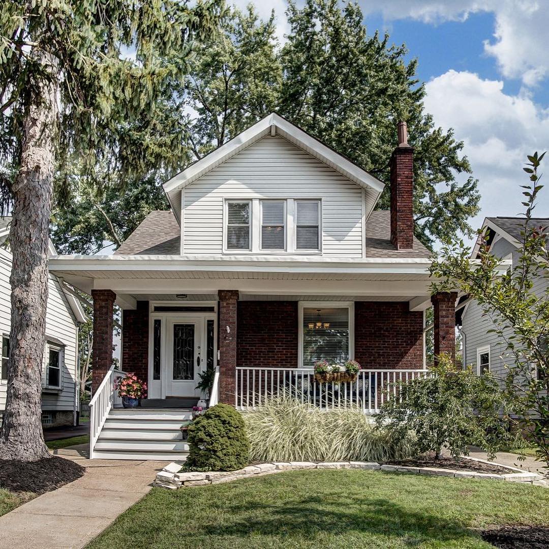 Charming home with red brick front porch. Photo by Instagram user @buildcollectivehomes