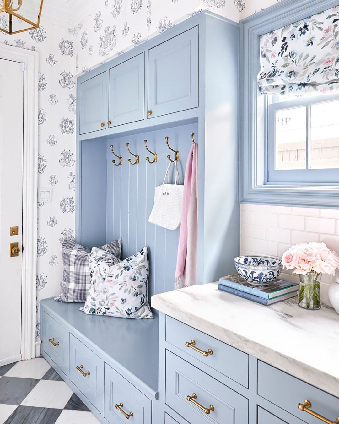Blue and floral mudroom design. Photo by Instagram user @caitlinwilsondesign