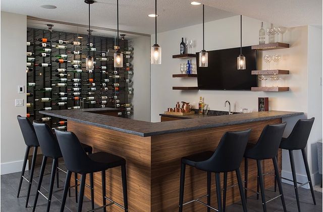 Home wine bar with wine display and bar with bar chairs. Photo by @toddhillhomes