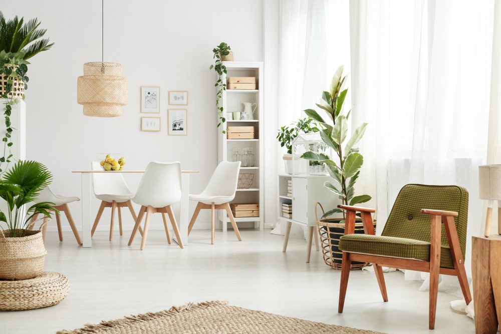 A decorated room with white, green, and wooden furniture