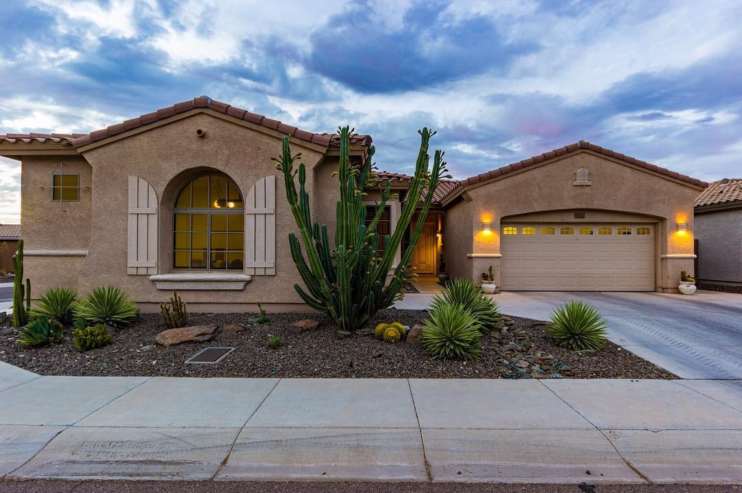 Front view of a single-family home with brown stuccio and a cactus in the front yard Photo by Instagram user @dannybrownaz