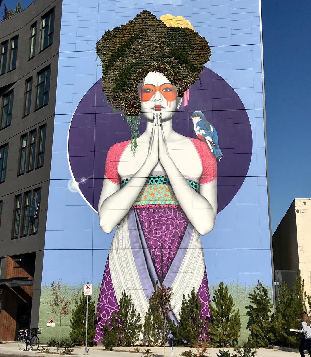 Large mural of a woman on the side of a building in Portland photo by Instagram user @thealaskabarbie