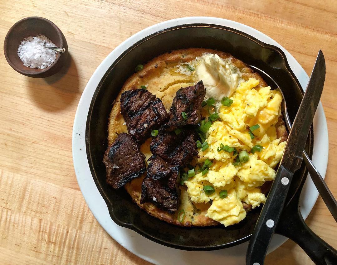 Overhead view of breakfast skillet dish with steak and eggs Photo by Instagram user @tastyndaughters