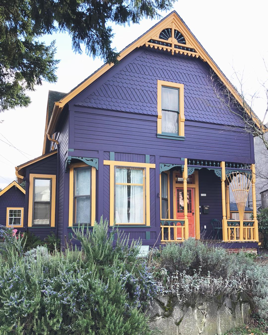 Front of single-family home painted purple with yellow trim Photo by Instagram user @housesofportland
