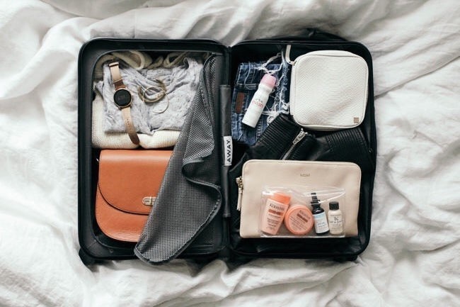 Suitcase with minimalist packing. Photo by Instagram user @youliveoncevacations
