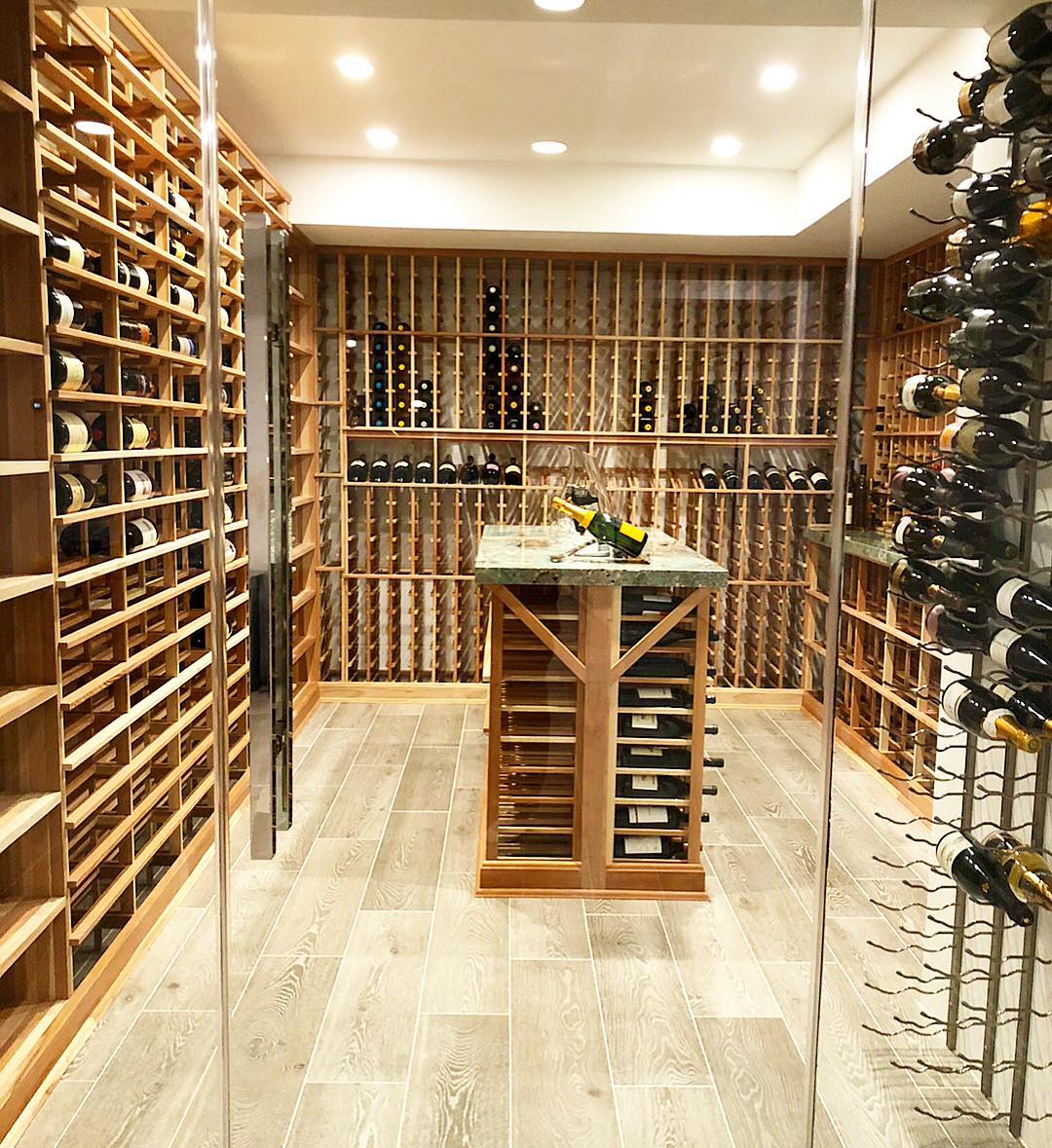 Wine Room with a Wood Tasting Table in the Center. Photo by Instagram user @mercer.built