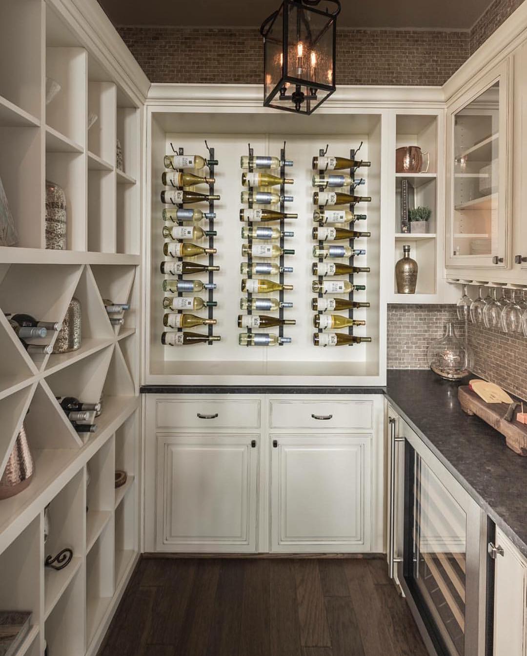 Wine Bottles Stored on the Wall of the Kitchen. Photo by Instagram user @creativehousedesigninterior