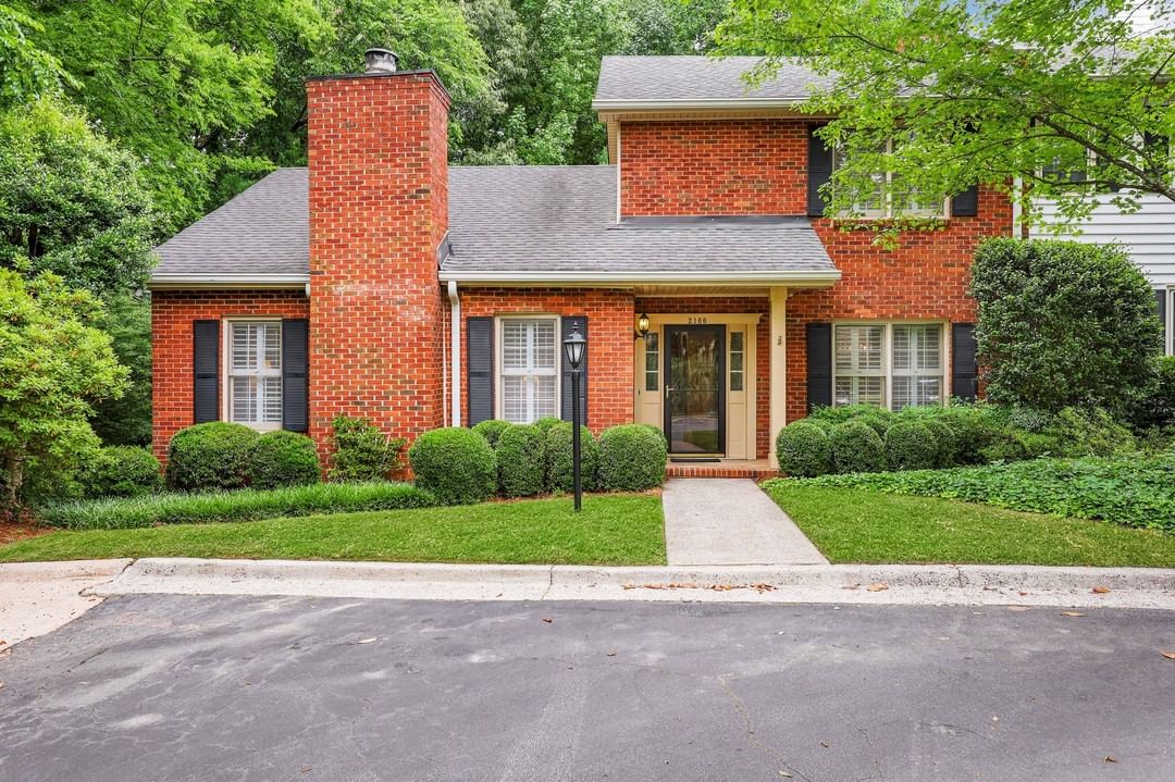 brick two story townhome with chimney. photo via Instagram user @simpleshowing