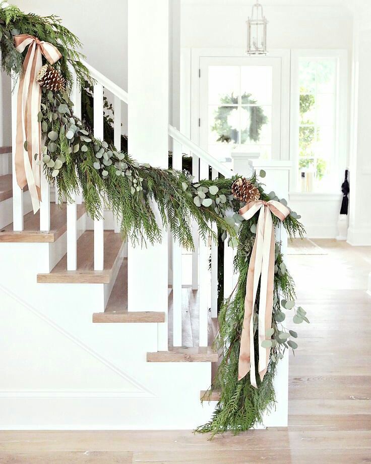 Staircase in the Front Hall Decorated with Green Garland. Photo by Instagram user @brookside_nursery