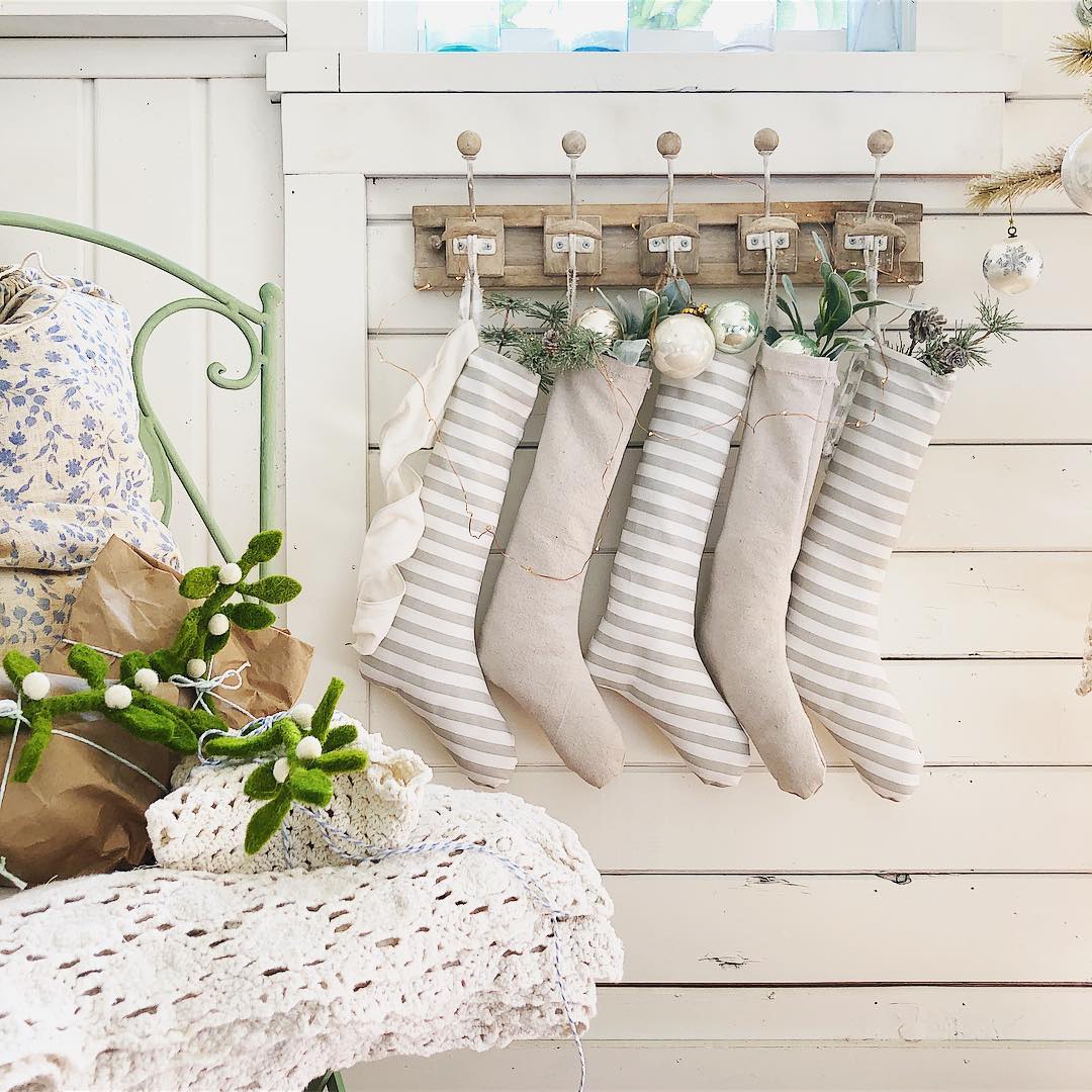 Homemade Christmas Stockings Made from Socks Hanging on Wall. Photo by Instagram user @bluelinencottage