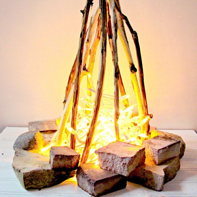 Faux Campfire Made from Foil, Fabric, Rocks, and Lights. Photo by Instagram user @craftgawker