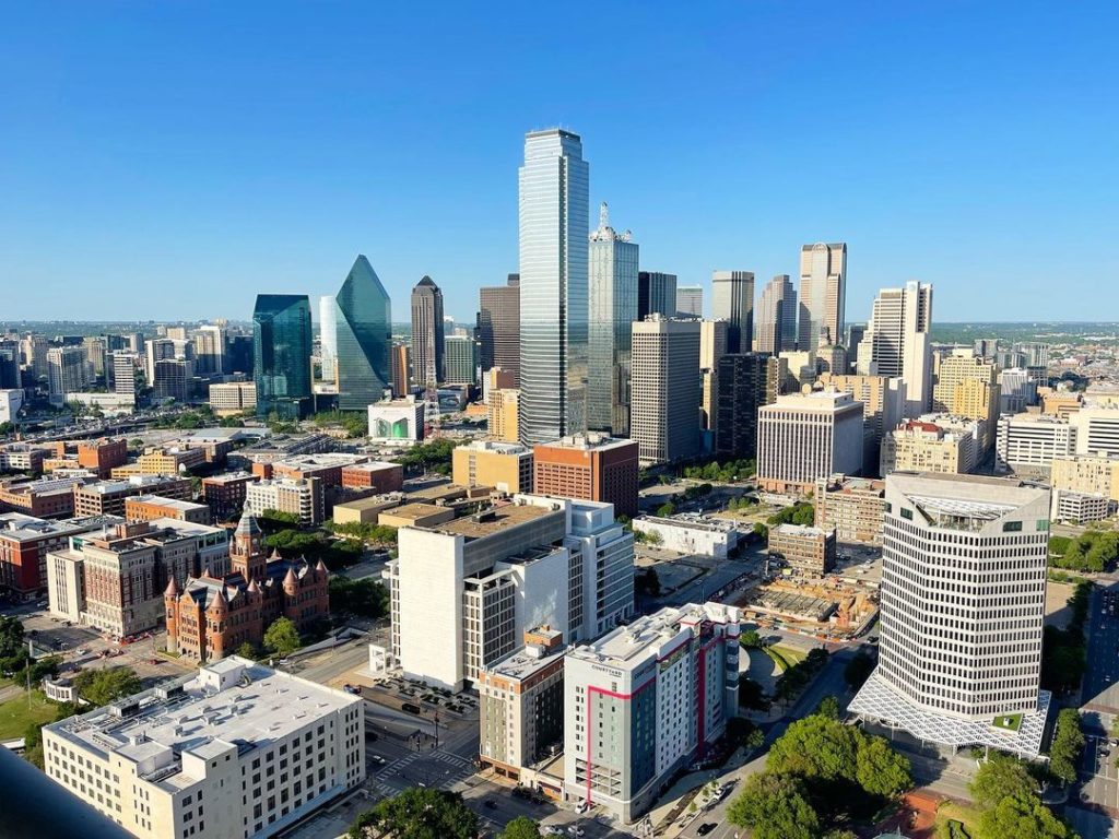 Aerial view of Dallas skyline in blue skies. Photo via Instagram user @joshlmcdonald