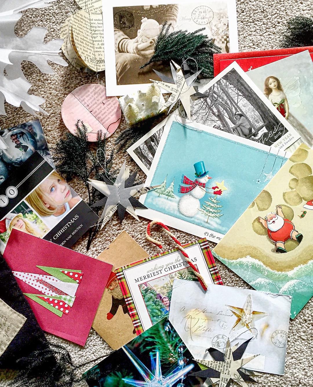 Different Varieties of Christmas Cards Spread Out on the Floor. Photo by Instagram user @tdoeswool