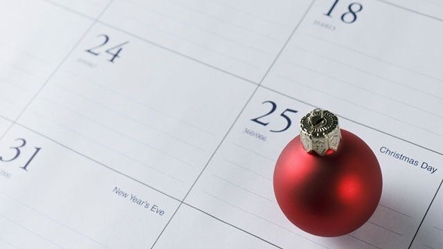Circular, Red Christmas Tree Ornament on Top of a Calendar. Photo by Instagram user @nestorganizing