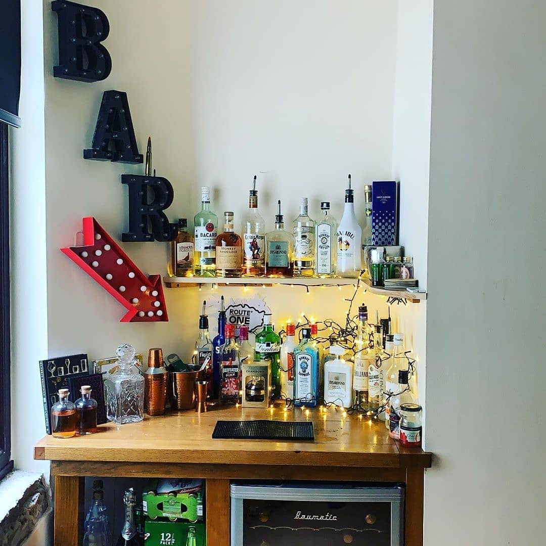 Home Bar with Fridge Stocked with Liquor and Beer. Photo by Instagram user @cocktailcatalog