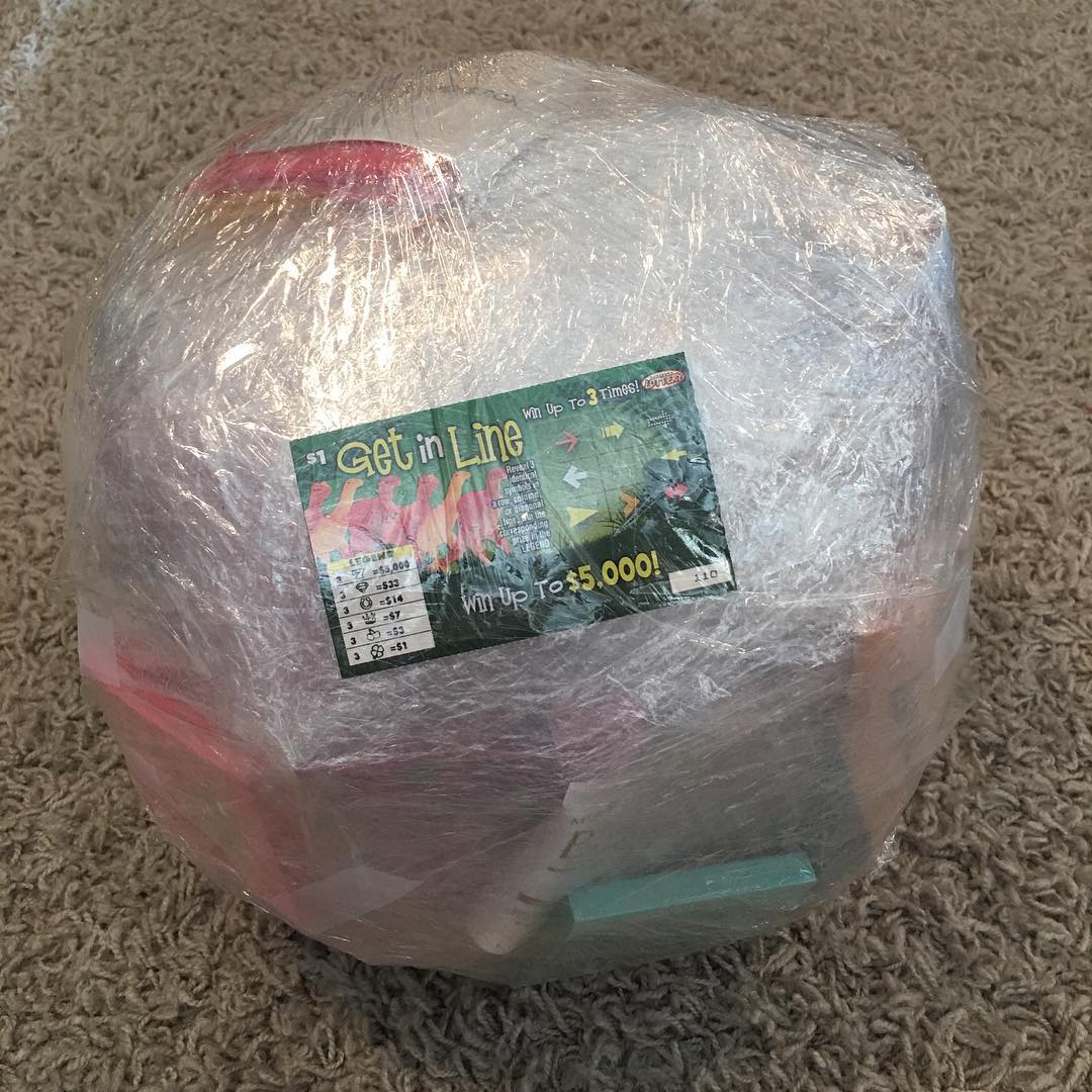 Large Ball of Saran Wrap with Christmas Present Inside. Photo by Instagram user @shoppingkim