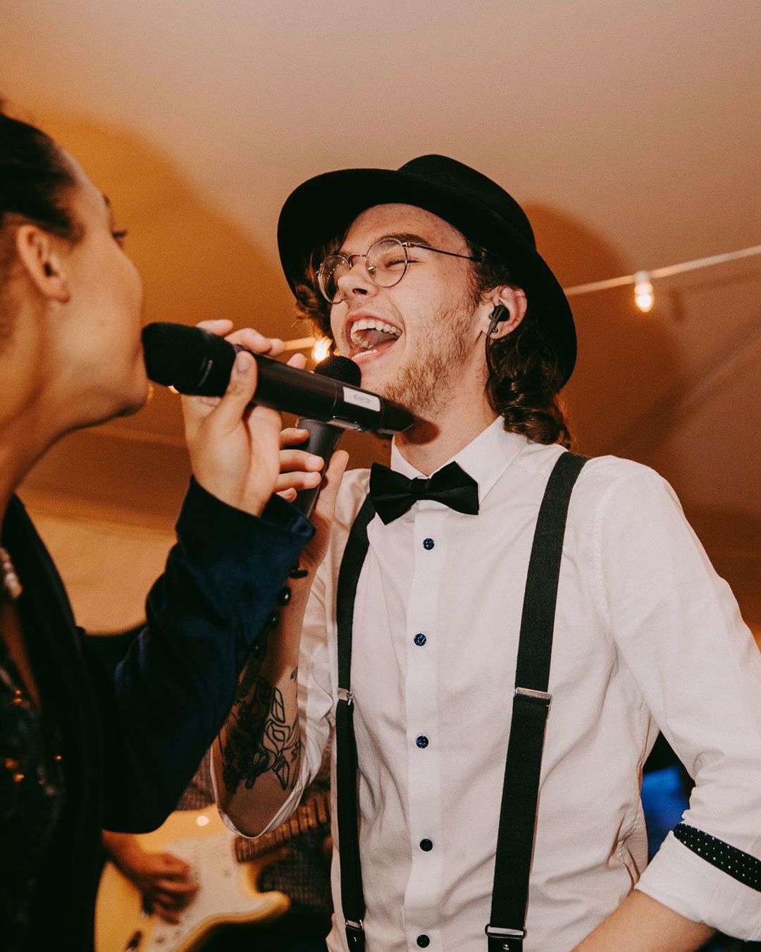 Party Guests Singing into Microphones at a Holiday Party. Photo by Instagram user @speechlessmusic
