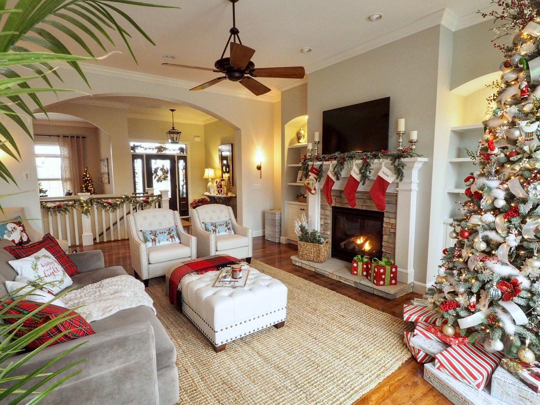 Living Room with Christmas Tree, Stockings Above the Fireplace, and Other Christmas Decorations. Photo by Instagram user @wowilovethat