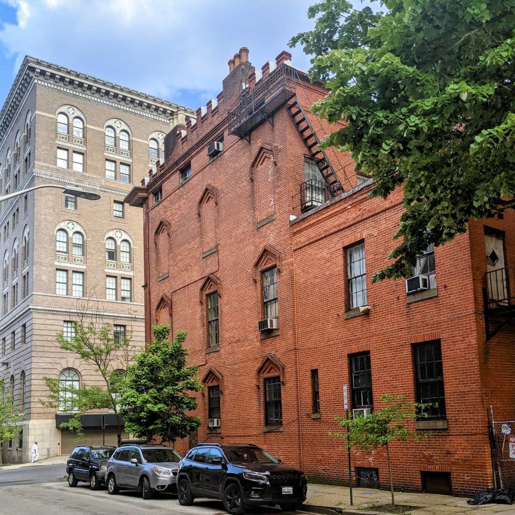 Red brick apartment building in Mount Vernon, Baltimore. Photo by Instagram user @marketcenterbalt