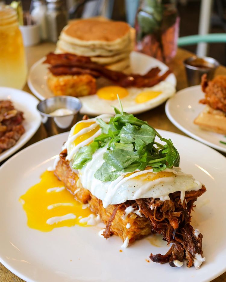 Breakfast plates with pulled pork hash, buttermilk pancakes, fried chicken and waffles from Poppy and Rose in Los Angeles. Photo by Instagram user @poppyandrosela