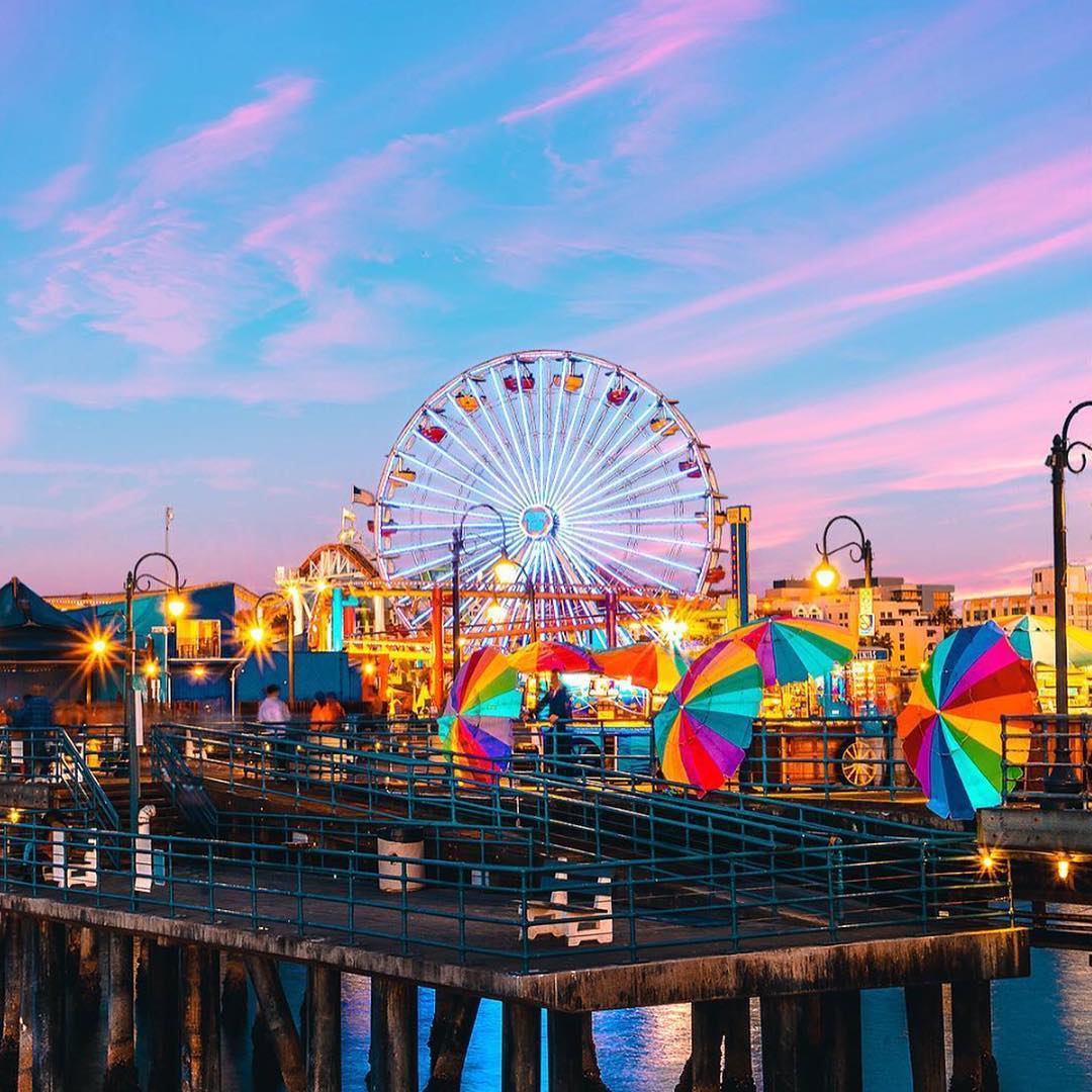 Attractions at the Santa Monica Pier Lit Up At Dusk. Photo by Instagram user @santamonicapier