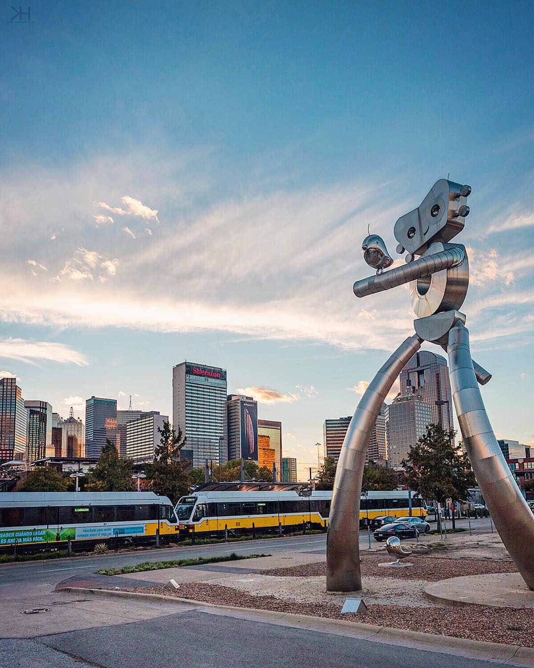Large metal sculpture with train and Fort Worth skyline in background Photo by Instagram user @kevinhannphoto