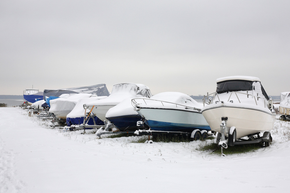 Many boats with covers, on trailers, in Winter.
