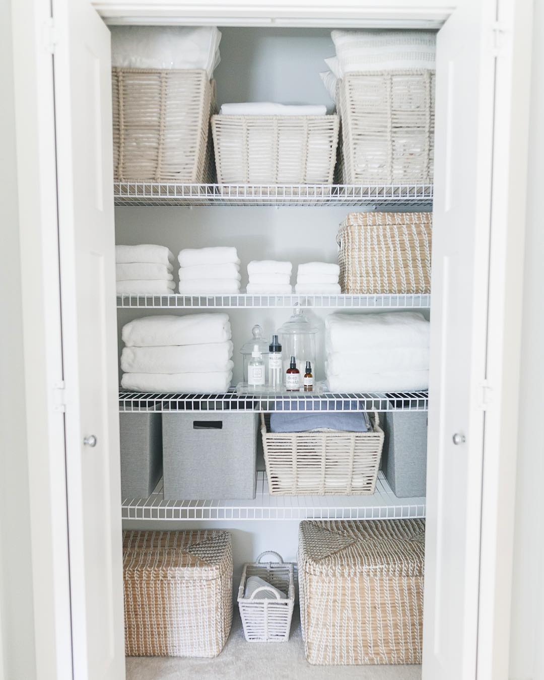 Organized bathroom closet. Photo by Instagram user @lauramayinteriors