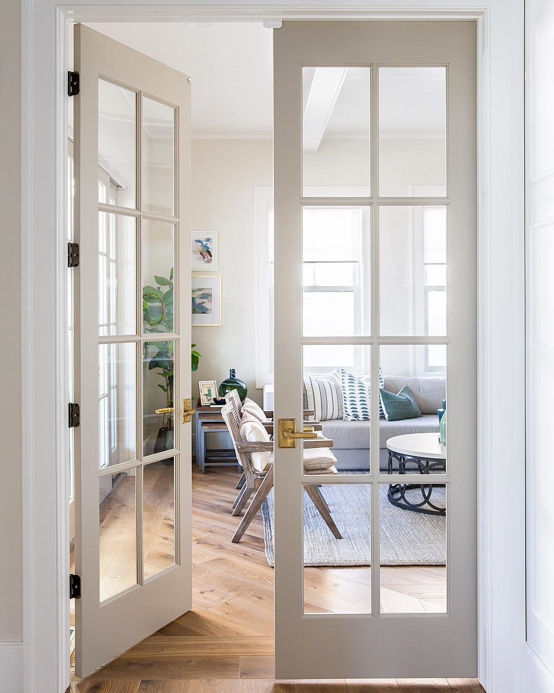 French-style doors opening into living room. Photo by Instagram user @sitamontgomeryinteriors