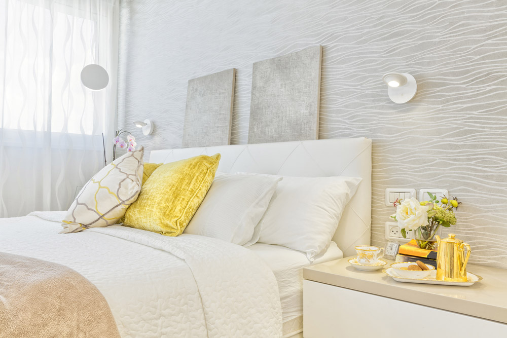 Feng shui bedroom interior design featuring white and gold colors.