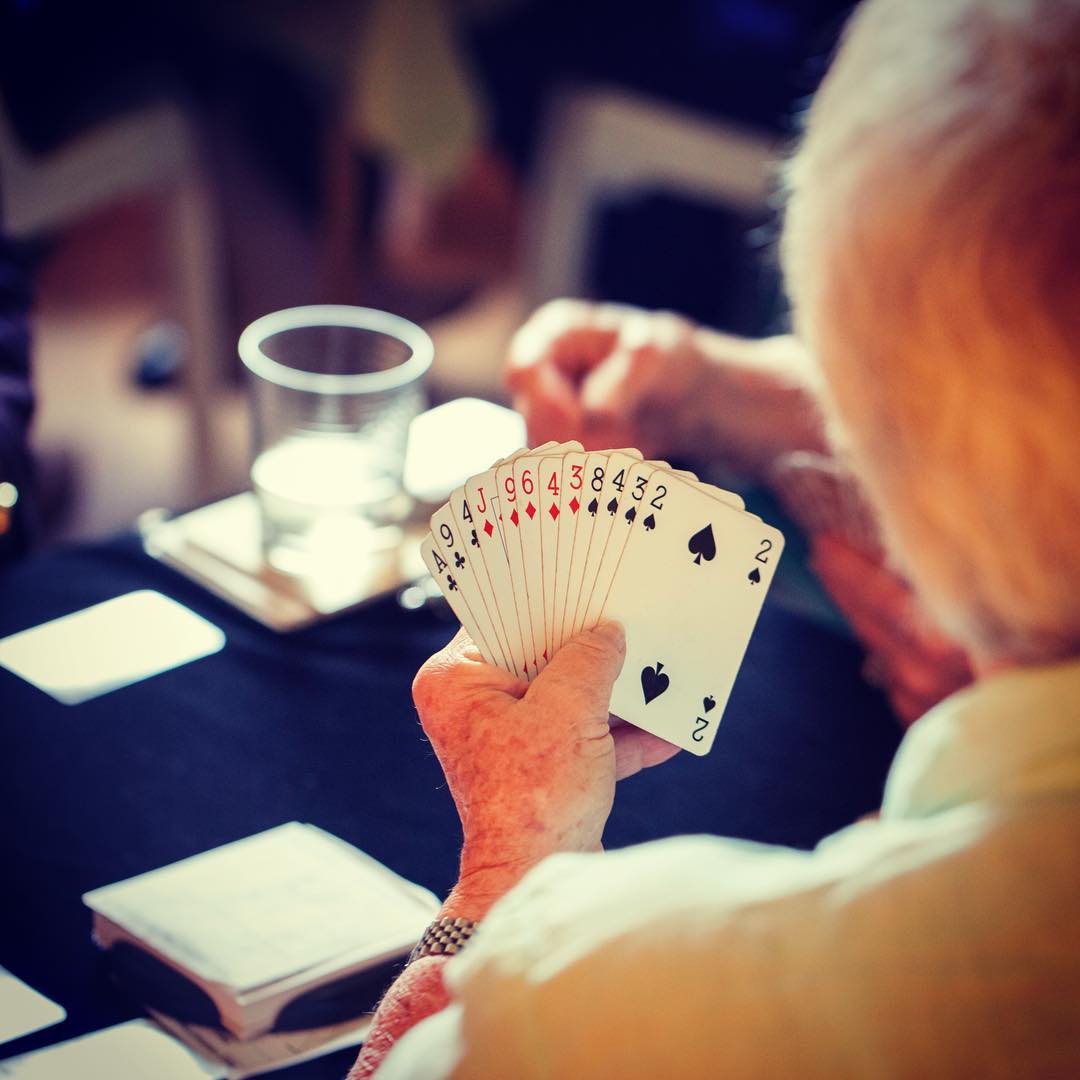 Elderly Woman Playing Cards. Photo by Instagram user @karunahospice
