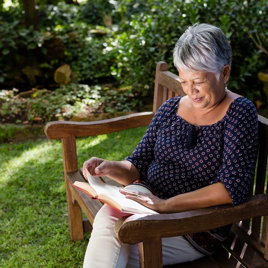 Elderly Woman Reading a Book. Photo by Instagram user @fallbrookglenofwesthills
